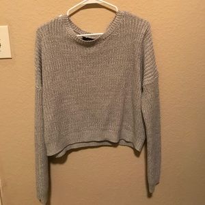 A crops sweater and black high rise jeans